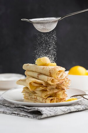 pancakes-covered-with-powdered-sugar_23-2148531629.jpg