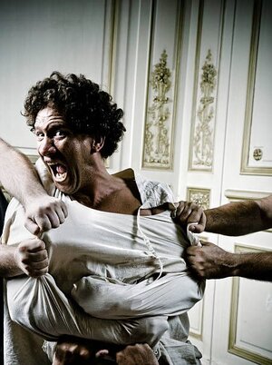 people-holding-angry-young-man-in-straight-jacket.jpg
