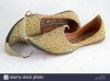 a-pair-of-ornately-decorated-arabian-style-pointy-shoes-on-a-plain-J2MG19.jpg