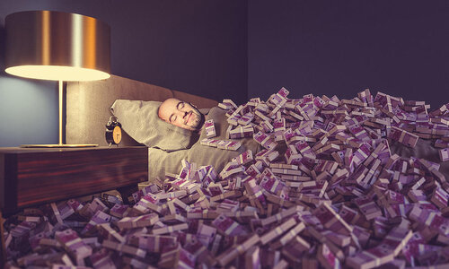 man-sleeping-in-bed-covered-with-euro-money-gualtiero-boffi.jpg